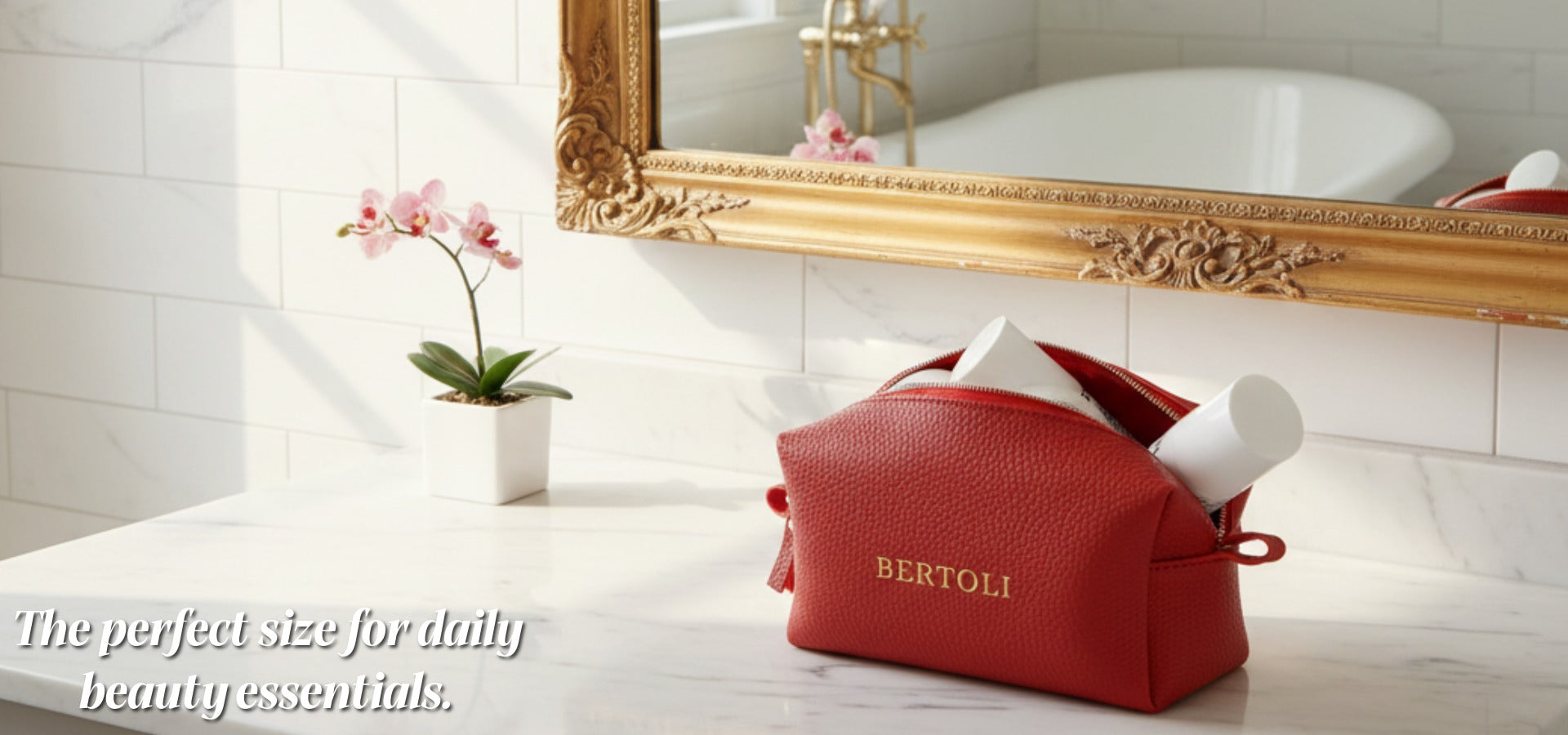 Red gift bag with 'BERTOLI' branding on a bathroom counter, featuring a decorative mirror.slider_item_FnkDBN
